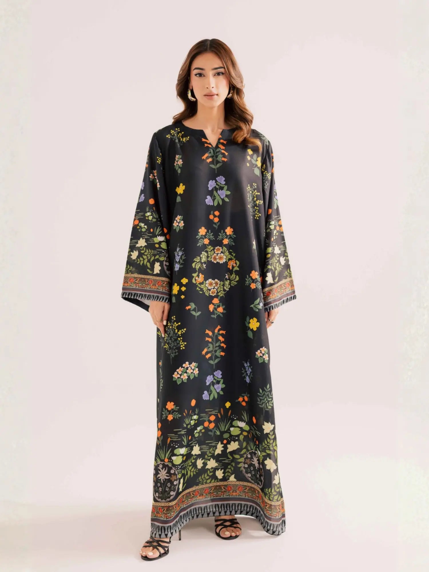 Woman wearing a black floral dress on a white background