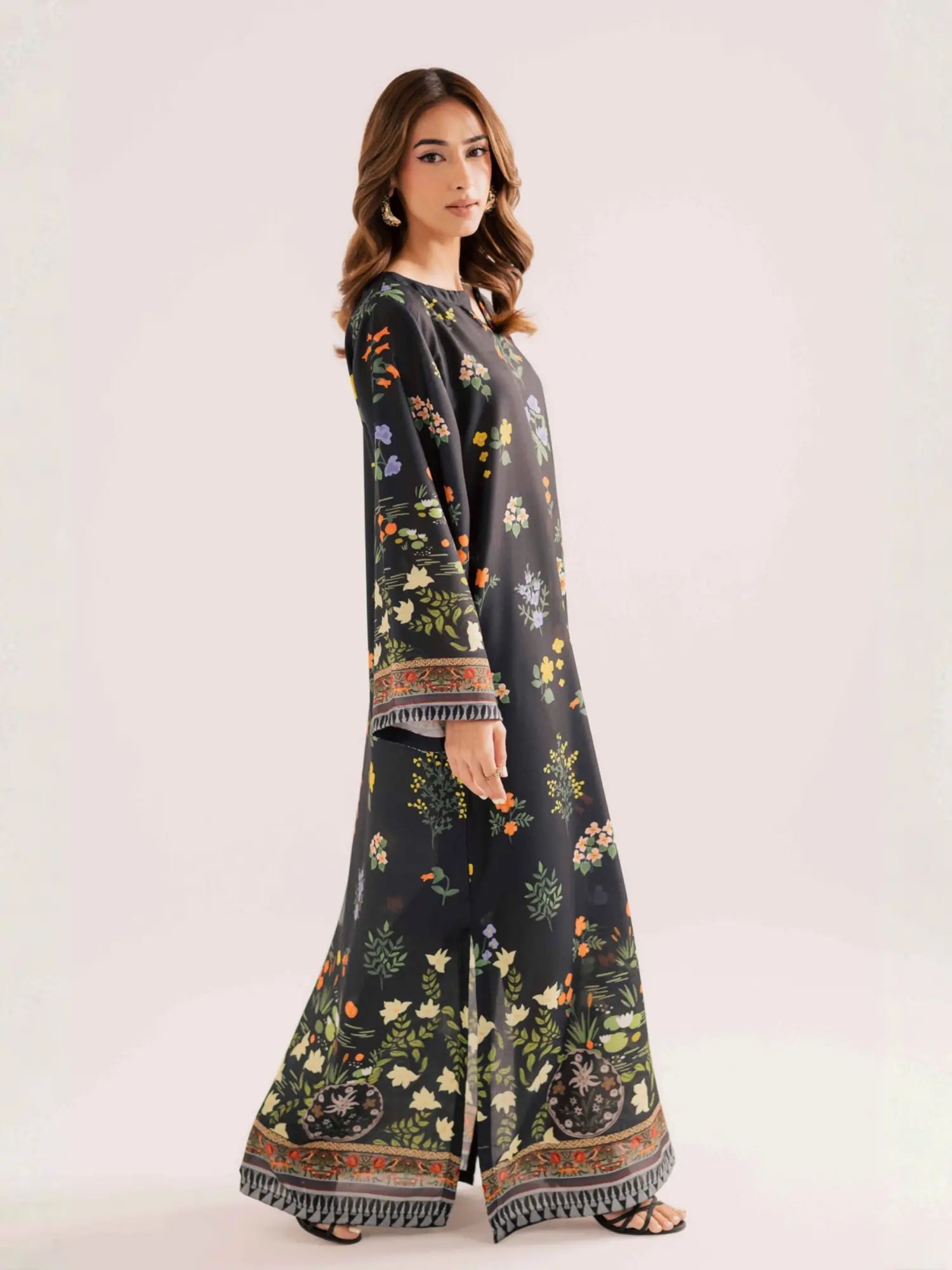 Woman wearing a long floral dress on a white background