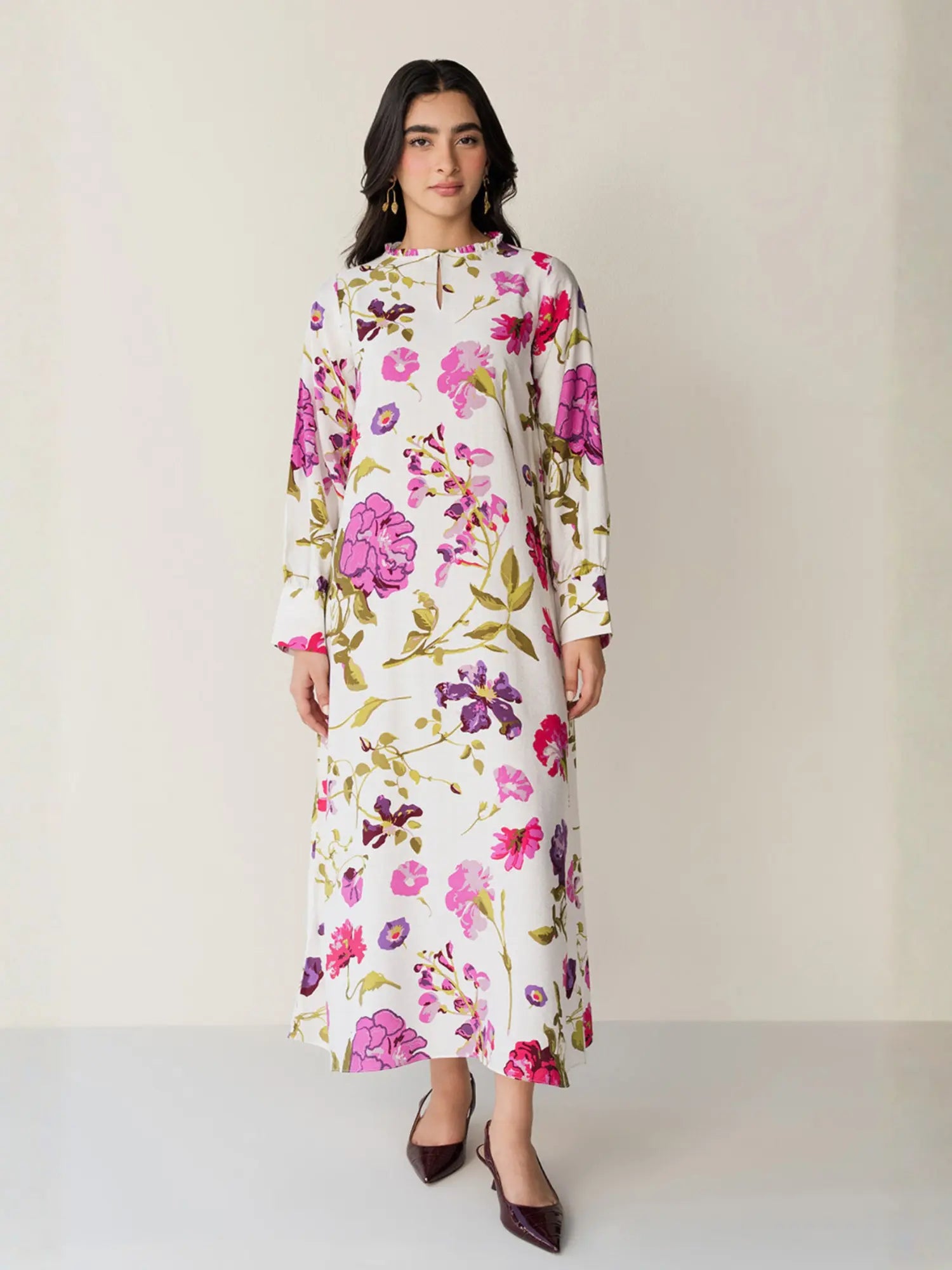 Woman wearing a floral dress on a plain background