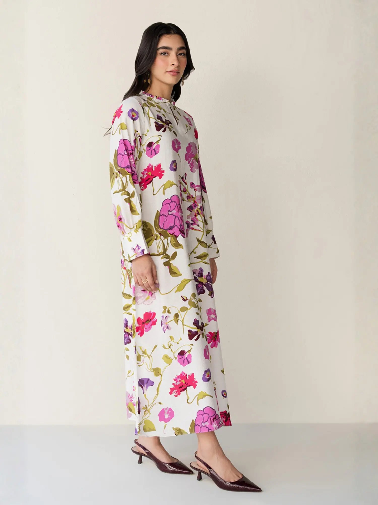 Woman wearing a floral dress on a plain background