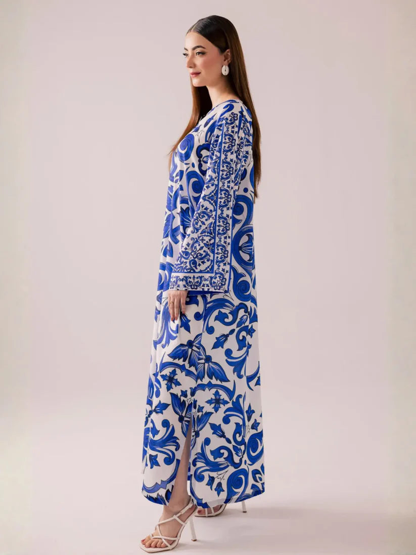 Woman wearing a blue and white patterned outfit on a plain background