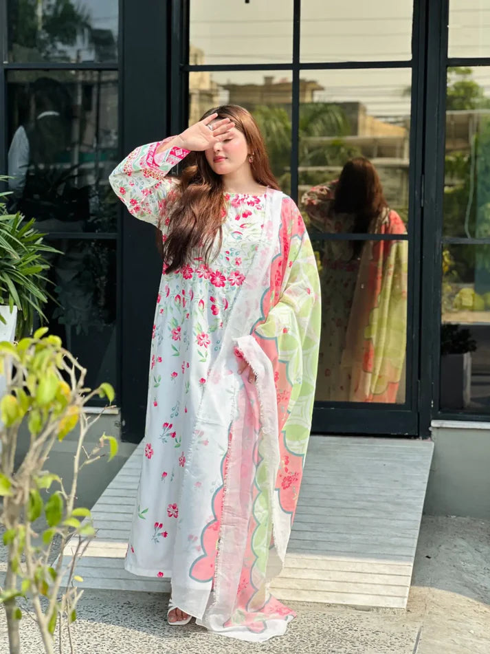 Woman wearing a floral kimono-style dress standing outdoors.