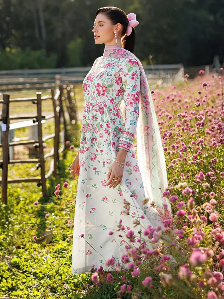 Woman in a floral dress standing in a field of pink flowers