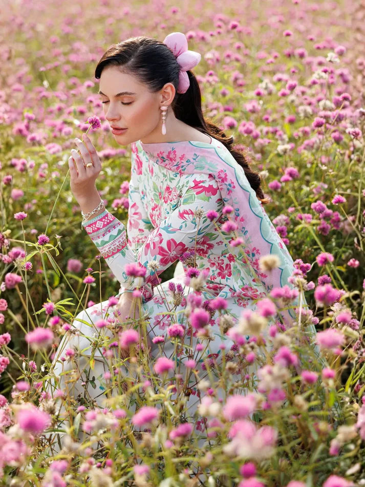Woman in a floral dress standing in a field of pink flowers