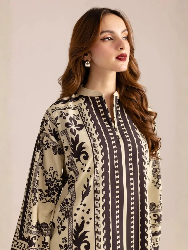Woman wearing a patterned dress with a neutral background