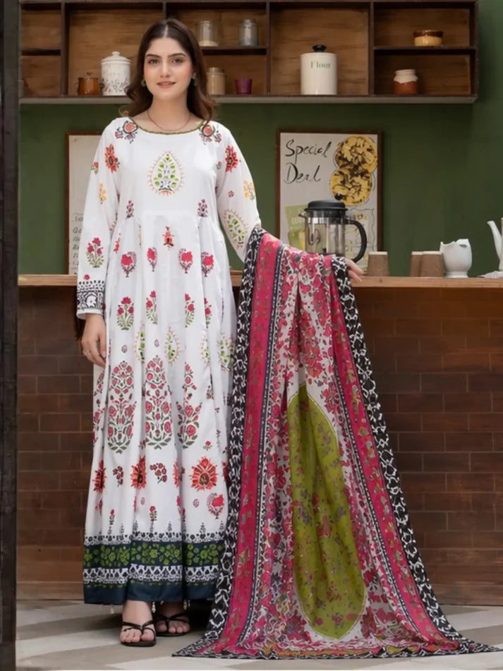 Woman holding a floral dress and dupatta in a room with shelves in the background