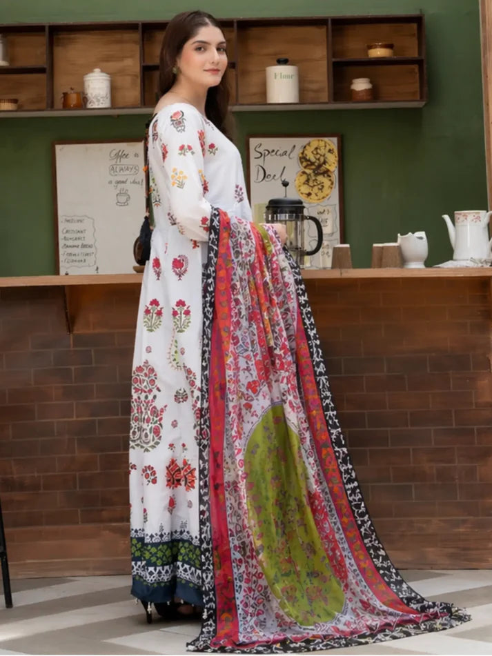 Woman wearing a white floral dress with a colorful dupatta in an indoor setting.