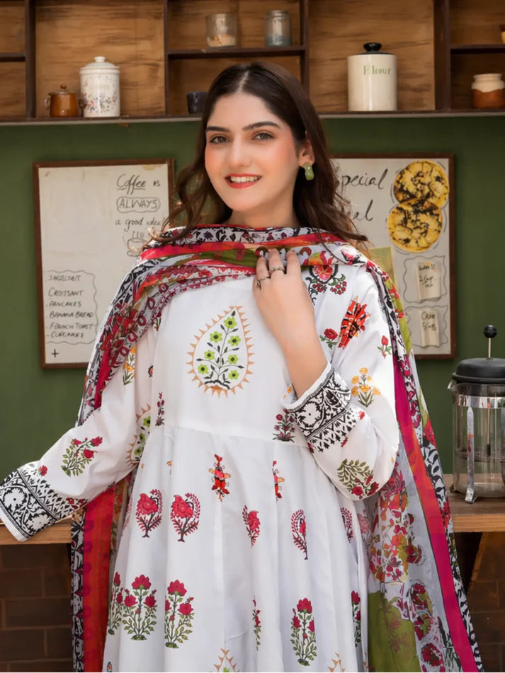 Woman wearing a white embroidered outfit with a colorful dupatta in a kitchen setting
